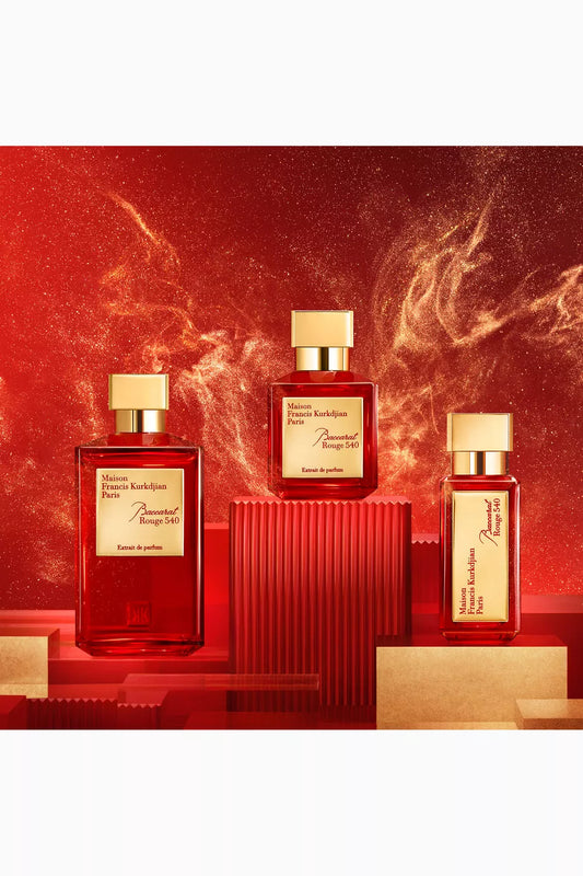 Three red perfume bottles with gold caps on a red background baccarat rouge 540 extrait de parfum