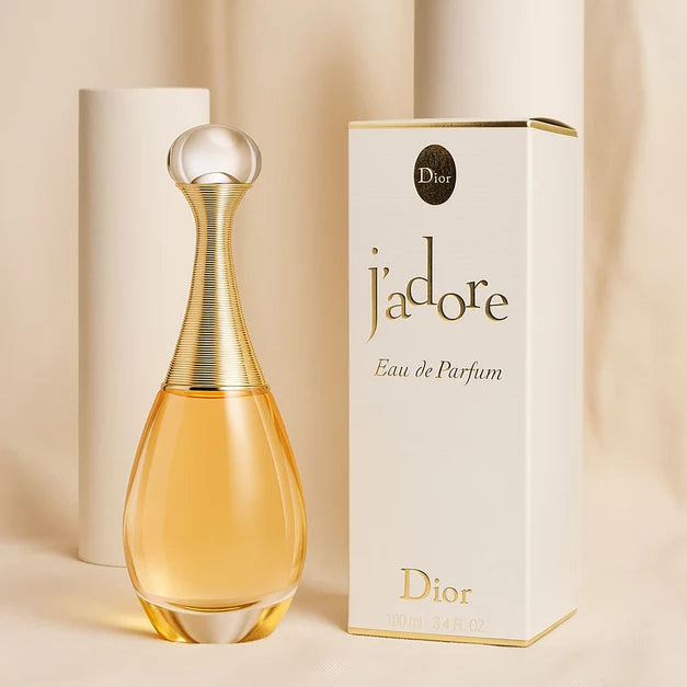 Dior j'adore Eau de Parfum bottle and packaging on a beige background