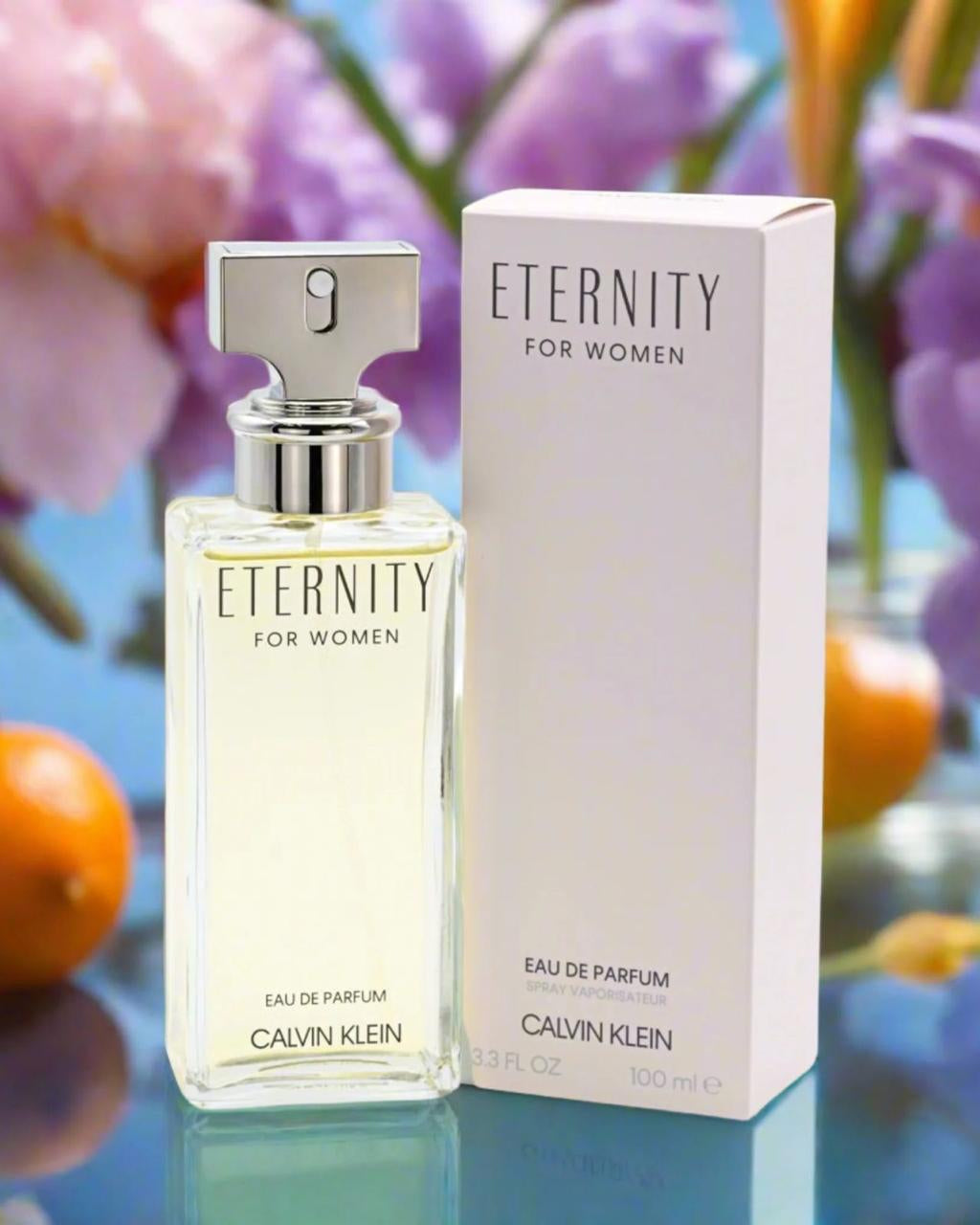 Calvin Klein Eternity for women perfume bottle and packaging with flowers in the background